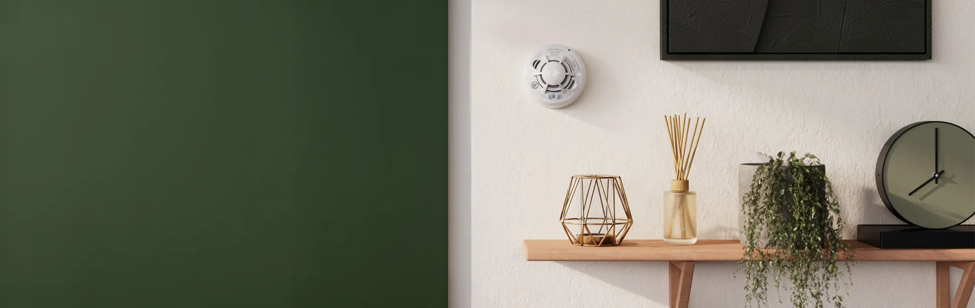 Vivint's combo Smoke & CO Detector is attached to a white wall next to decor.